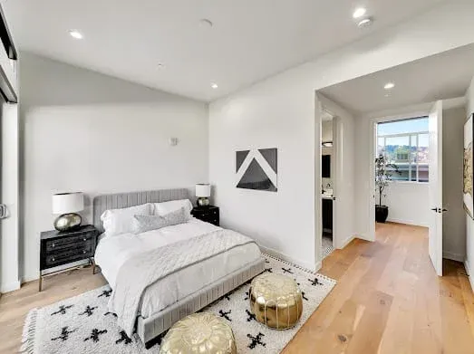 124 S Croft Ave — Bedrooms: Secondary bedroom with geometric art and gold accent stools