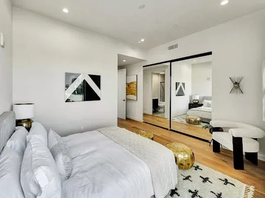 124 S Croft Ave — Bedrooms: Modern bedroom with mirrored closet doors and city views
