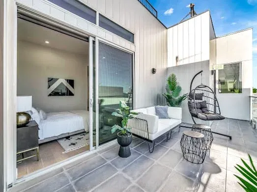 124 S Croft Ave — Exterior: Rooftop terrace with bedroom access, hanging chair, and modern outdoor furniture