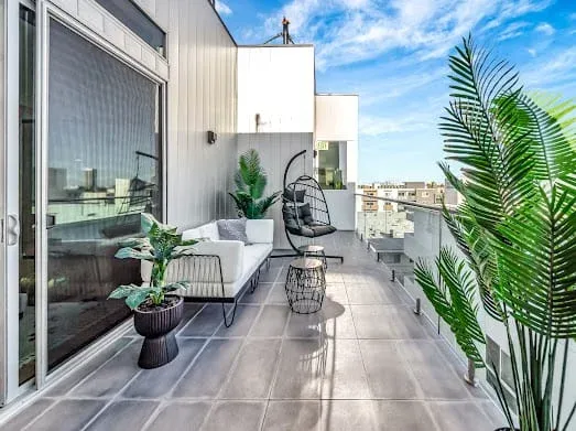 124 S Croft Ave — Exterior: Spacious rooftop terrace with contemporary seating and lush plantings