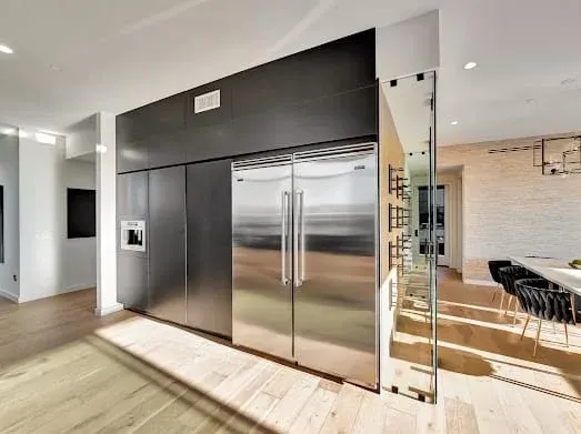 124 S Croft Ave — Kitchen: Contemporary kitchen with built-in stainless steel refrigerator and bar seating