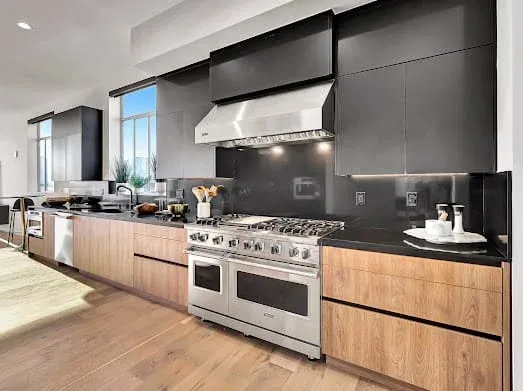 124 S Croft Ave — Kitchen: Professional-grade gas range with hood and wooden cabinetry