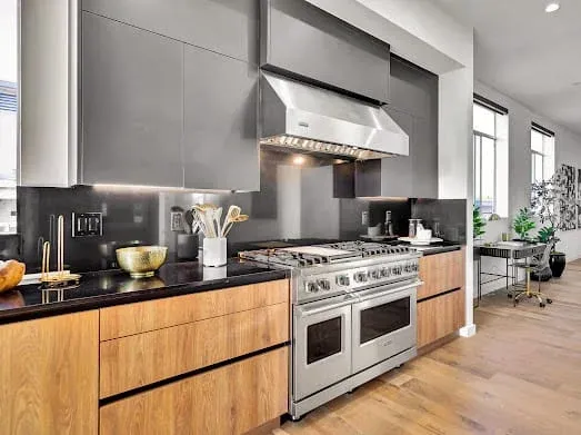124 S Croft Ave — Kitchen: Modern cooking area with range hood and premium finishes