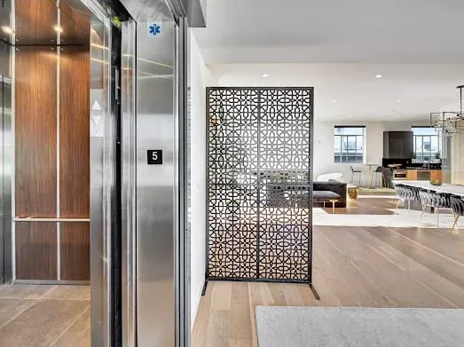 124 S Croft Ave — Living Areas: Modern living space with elevator entrance and decorative screen partition