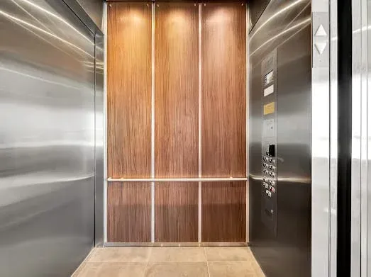 124 S Croft Ave — Living Areas: Luxury elevator interior with warm wood paneling and contemporary finishes