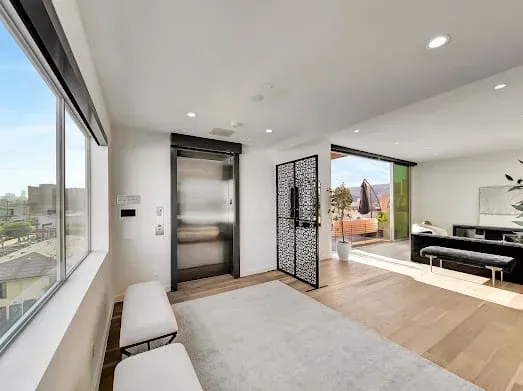 124 S Croft Ave — Living Areas: Open living area with floor-to-ceiling windows and panoramic city views