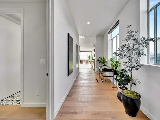 124 S Croft Ave — Living Areas: Modern hallway with curated plants and seamless design flow