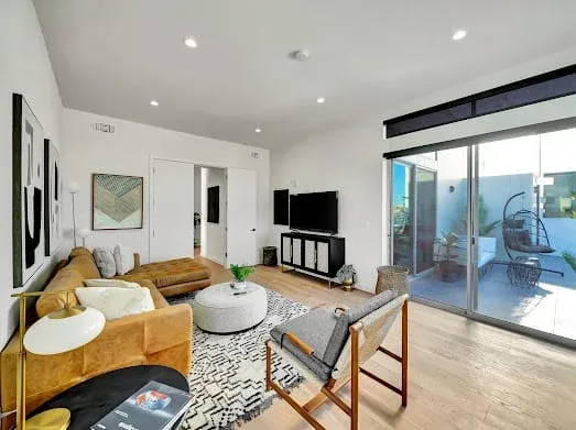 124 S Croft Ave — Living Areas: Great room with sectional seating and direct patio access